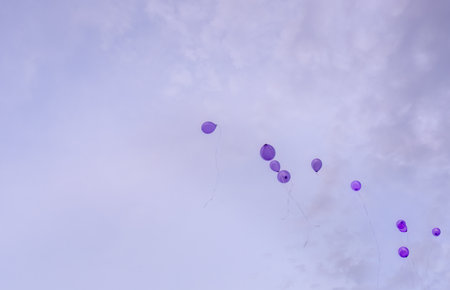 Purple balloons flying in the sky.の写真素材