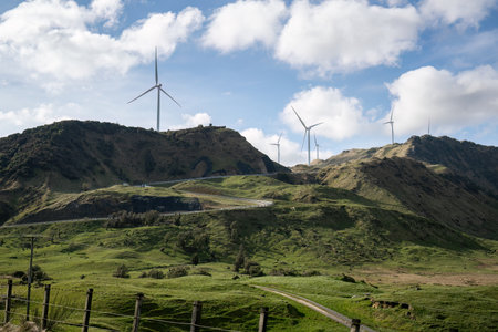 Wind farm on top of the hill under a fluffy cloud sky. Hawke's Bay. New Zealand.の写真素材