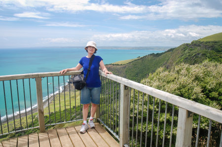 Female tourist posing for photos at Te Toto Gorge lookout. Raglan. Waikato. New Zealand.の写真素材