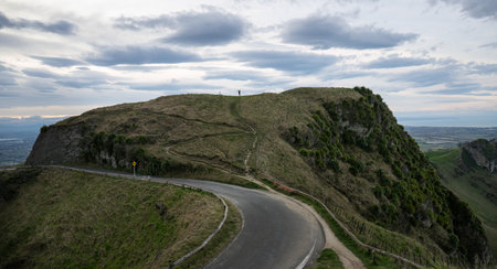 Woman raising arms and standing on top of the hill. Te Mata Peak. Hawkeâs Bay.の写真素材
