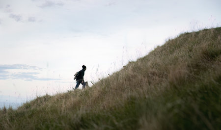 Man hiking steep uphill. Te Mata Peak track. Hawkeâs Bay.の写真素材