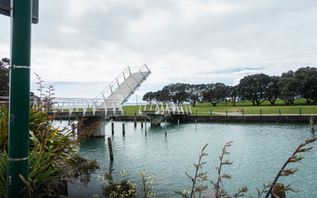 Bascule pedestrian bridge lifting to let boats pass through at Milford Beach Reserve. Auckland.の写真素材