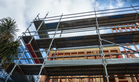 Low angle view of residential houses under construction with metal scaffolding around them. Auckland.の写真素材