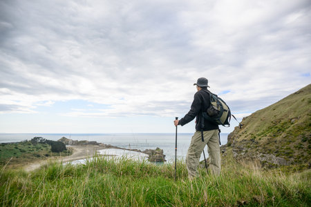 Man hiking the Deliverance Cove track. Castlepoint. Wairarapa. New Zealand.の写真素材