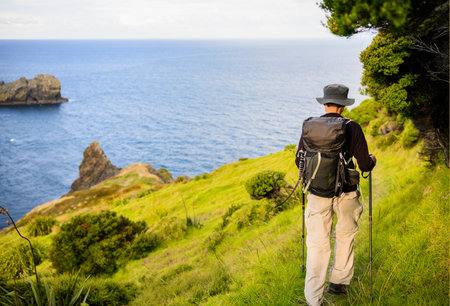Backpacker hiking Cape Brett Track. Bay of Islands.の写真素材