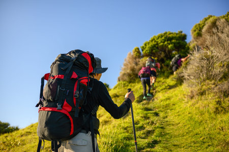 Backpacker hiking Cape Brett Walkway. Unrecognizable people in the distance. Bay of Islands.の写真素材