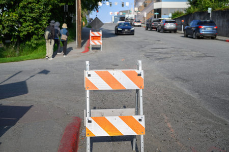 Orange traffic detour road sign on the road. Roadworks in downtown Anchorage. Alaska.