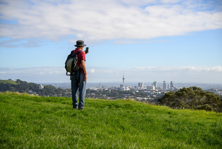 Tourist taking photos of Sky Tower from One Tree Hill. Auckland.の写真素材