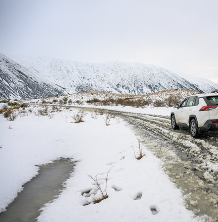 Car driving on snow-covered mountain road. Twizel. South Island.の写真素材