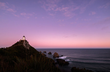 Nugget Point Lighthouse at sunset. Catlins Coast. Otago. South Island. New Zealand.