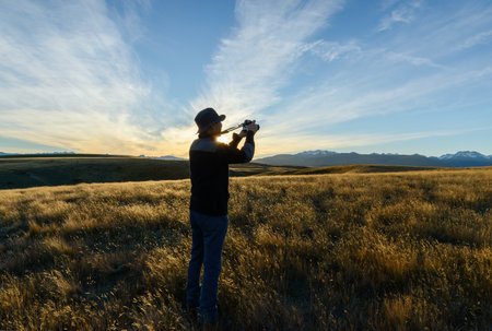 Tourist taking photos at Peninsula Walkway, Lake Tekapo, South Island.の写真素材