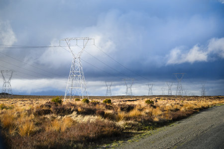 Power pylons and power lines along the Desert Road under a stormy sky. North Island. New Zealand.の写真素材