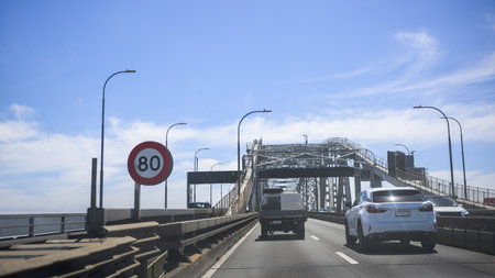 Traffic on Auckland harbour bridge. 80km per hour speed limit sign on the road. Auckland. New Zealand.の写真素材