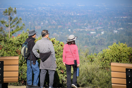 Friends enjoying sweeping views of the Silicon Valley. Villa Montalvo Lookout Point. Saratoga, California.