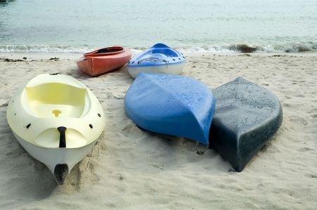 A row of Kayaks on the beachの写真素材