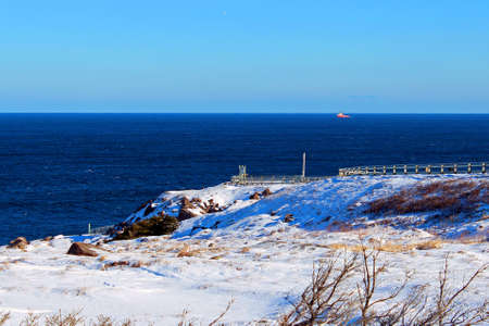 Beautiful landscape on a sunny winter day with a ship in the distanceの写真素材