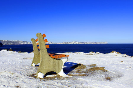 A wooden bench and winter landscapeの写真素材