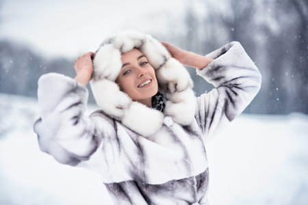 Woman have fun on the snow in winter forest