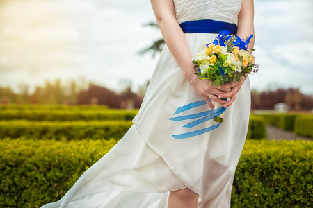 bridal bouquet of flowers in hands of the brideの写真素材