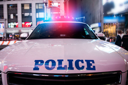 A police car rushes to the emergency call with lights turned on in the city street