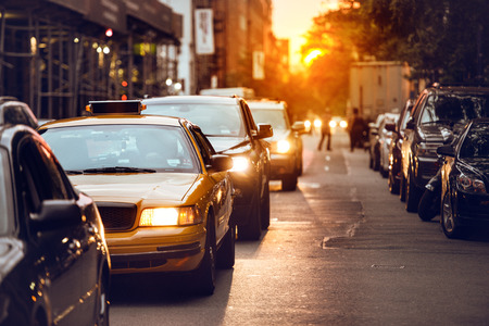 Car traffic on New York City street at sunset timeの写真素材