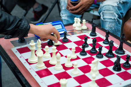 people playing quick chess on the street with timer.