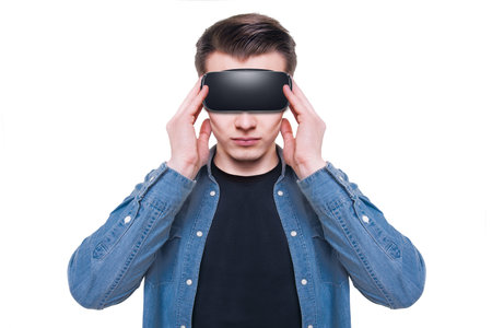 Young man wearing virtual reality goggles isolated on white background