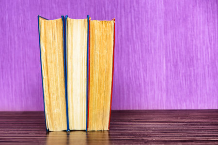 Old books on a wooden shelf.の写真素材