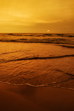 Sunset over the ocean beachの写真素材