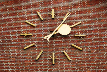 a large clock on the brick wall