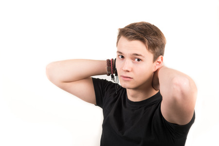 portrait of handsome man honding hands behind the headの写真素材