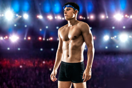 Handsome man wearing swim goggles at the poolの写真素材