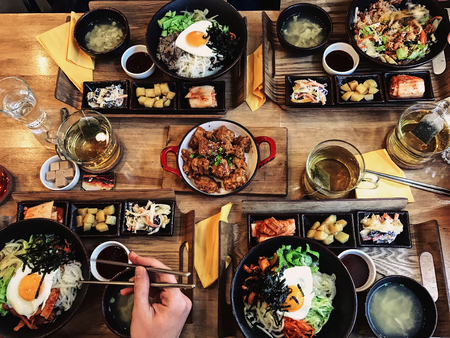 Healthy food on wooden table. Top view. people having dinner in the restaurant.の写真素材