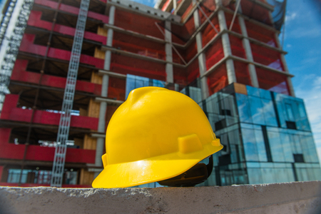 People on the construction and safety technic concept photo. Yellow helmet on the construction site.の写真素材