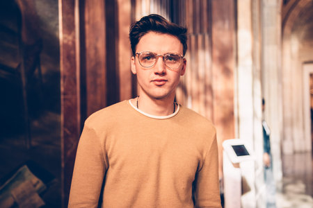 Student handsome man wearing eyeglasses and visiting art gallery in museumの写真素材