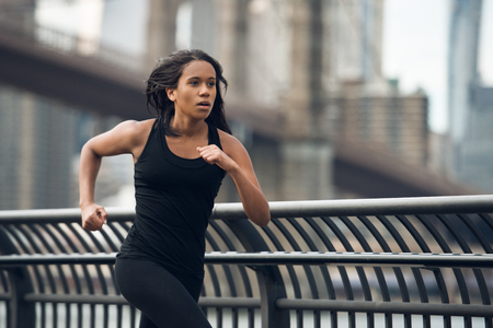 African american woman running in New York City at the morningの写真素材