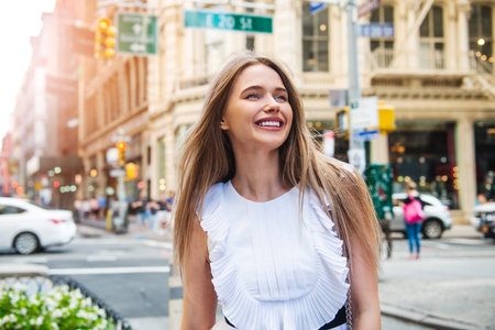 A beautiful woman walks on city street to the office at the morning and enjoy her day