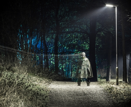Ghost standing under the street lightの写真素材