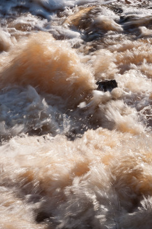 Foaming water in raging rapids in springの写真素材
