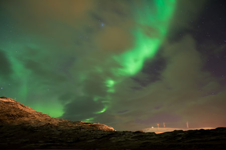 Green aurora borealis in the sky in Arctic Norway in late autumn
