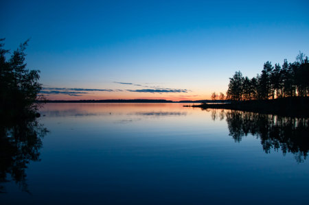 Early summer night by a calm lake in Finlandの写真素材