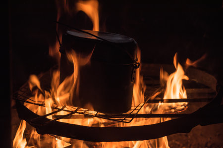 Cooking in a mess-tin over a warm fire in Pirkanmaa, Finlandの写真素材