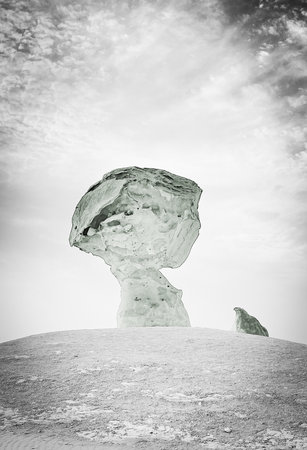 Iceberg in the desert against cloudy sky background. 3d renderingの写真素材