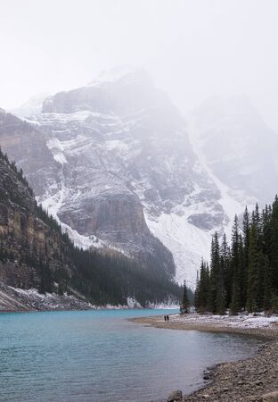 lake moraine and covered mountains, snow in banff national park Canadaの写真素材