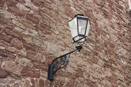 Old latnern hanging on a wallの写真素材