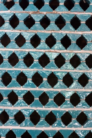 Patterned wall in blue ceramics with holesの写真素材