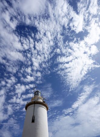 Lighthouse with blue sky and cloudsの写真素材