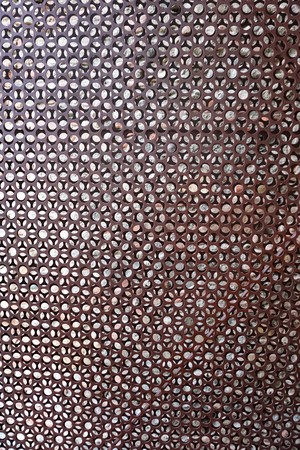 Metallic pattern on a wallの写真素材