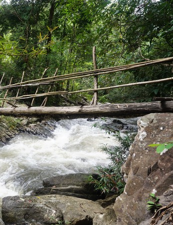 bamboo bridge with waterfall in Thailand jungleの写真素材