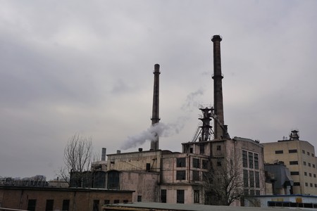 Industrial area with pipes and chimney with smoke in Beijing Chinaの写真素材